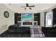 Inviting living area with a fireplace, decorative shelves, and a mounted TV at 12838 Wildflower Meadow Dr, Riverview, FL 33579