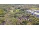 An aerial view of the property reveals lush greenery and a serene golf course nearby at 13702 Sweetwater Cove Pl # 25, Tampa, FL 33613