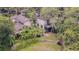 Backyard features a grill, screened-in porch, and lush greenery at 13702 Sweetwater Cove Pl # 25, Tampa, FL 33613
