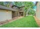 A serene backyard with lush green grass and beautiful landscaping at 13702 Sweetwater Cove Pl # 25, Tampa, FL 33613