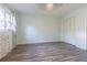 Relaxing bedroom featuring hardwood floors, closet, and natural light at 13702 Sweetwater Cove Pl # 25, Tampa, FL 33613