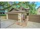 Charming two-story home featuring a garage and quaint landscaping at 13702 Sweetwater Cove Pl # 25, Tampa, FL 33613