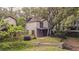 Two story home in lush setting, with large palms and a fenced yard at 13702 Sweetwater Cove Pl # 25, Tampa, FL 33613