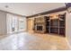 Spacious living room featuring a cozy fireplace, tiled floor, and large window at 13702 Sweetwater Cove Pl # 25, Tampa, FL 33613