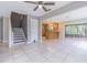 Open-concept layout with tile flooring leading to the kitchen and sliding glass doors at 13702 Sweetwater Cove Pl # 25, Tampa, FL 33613