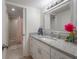 Bright bathroom featuring a granite countertop and a vanity with white cabinets at 13851 Lake Point Dr, Clearwater, FL 33762