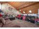 Bonus room featuring unique wood ceiling, stone wall, and fun entertainment space at 13851 Lake Point Dr, Clearwater, FL 33762