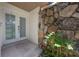 Covered entryway featuring double doors and a stone accent wall at 13851 Lake Point Dr, Clearwater, FL 33762