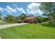 Charming home with a well-maintained front yard, paver driveway, and mature landscaping at 13851 Lake Point Dr, Clearwater, FL 33762
