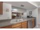 Kitchen featuring a stainless steel dishwasher and a view to the living room at 13851 Lake Point Dr, Clearwater, FL 33762