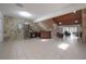 Large living area with tiled floors, stone walls, and a wood-paneled ceiling at 13851 Lake Point Dr, Clearwater, FL 33762