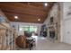 Living room features a stone fireplace, wood ceiling, and access to an enclosed lanai at 13851 Lake Point Dr, Clearwater, FL 33762