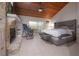 Main bedroom featuring a stone fireplace and access to the outdoor patio at 13851 Lake Point Dr, Clearwater, FL 33762