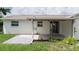 Covered back patio with a concrete pad and views of the landscaped backyard at 1806 11Th Sw St, Largo, FL 33778