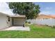 Spacious backyard with a covered patio, white fence, and ample space for outdoor activities at 1806 11Th Sw St, Largo, FL 33778