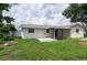 Large backyard features a fire pit, patio, and a covered seating area at 1806 11Th Sw St, Largo, FL 33778