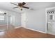 A bedroom with hardwood floors, mirrored closet doors, and an open ensuite bathroom at 1806 11Th Sw St, Largo, FL 33778