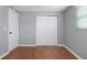 Bedroom features neutral gray walls, wood flooring, and closet at 1806 11Th Sw St, Largo, FL 33778