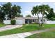 Inviting single-story home with a circular driveway and palm trees in the front yard at 1806 11Th Sw St, Largo, FL 33778