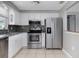 Well-lit kitchen featuring white cabinets, stainless steel appliances, and stylish backsplash at 1806 11Th Sw St, Largo, FL 33778