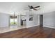 Open concept living area with hardwood floors connecting to a kitchen with stainless steel appliances at 1806 11Th Sw St, Largo, FL 33778