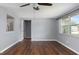 Bright living room with hardwood floors, neutral walls, and natural light from the windows at 1806 11Th Sw St, Largo, FL 33778