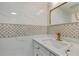 Elegant bathroom with marble countertops, decorative tile backsplash, and modern gold fixtures adding a luxurious touch at 19003 Cedar Ln, Lutz, FL 33548