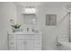 Updated bathroom features white vanity, framed mirror, and modern lighting at 19003 Cedar Ln, Lutz, FL 33548