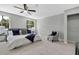 Spacious bedroom with plush carpeting, ceiling fan, and a comfortable bed adorned with stylish pillows at 19003 Cedar Ln, Lutz, FL 33548