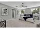 Bright and airy bedroom with neutral tones, ceiling fan, and comfortable furnishings at 19003 Cedar Ln, Lutz, FL 33548