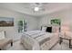 Cozy bedroom featuring a comfortable bed, soft lighting, and a picturesque window view at 19003 Cedar Ln, Lutz, FL 33548