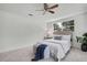 Comfortable bedroom with soft carpet, a ceiling fan, and a serene ambiance at 19003 Cedar Ln, Lutz, FL 33548