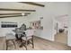 Charming dining room with exposed beams, modern chandelier, and seamless access to the kitchen and living areas at 19003 Cedar Ln, Lutz, FL 33548
