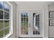 Inviting entryway with elegant French doors and natural light, creating a warm and welcoming first impression at 19003 Cedar Ln, Lutz, FL 33548