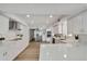 Spacious kitchen with stainless steel appliances, white cabinets, light countertops, and wood-look floors at 19003 Cedar Ln, Lutz, FL 33548