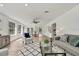 Open-concept living room with hardwood floors, a ceiling fan, and an abundance of natural light at 19003 Cedar Ln, Lutz, FL 33548