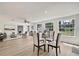Open-concept living and dining area with ample natural light, hardwood floors, and stylish furnishings, ideal for entertaining at 19003 Cedar Ln, Lutz, FL 33548