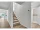 Entryway featuring staircase with carpet runner and hardwood flooring leading to the upstairs at 19003 Cedar Ln, Lutz, FL 33548