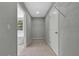 Walk-in closet with neutral colored carpet, wire shelving, and a view of the Primary bath at 19003 Cedar Ln, Lutz, FL 33548