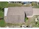 Aerial view of a well-kept home with a new roof, manicured landscaping, and a brick driveway at 1901 E Del Webb Blvd, Sun City Center, FL 33573