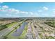 Community aerial view shows the layout of houses, roadways, and nearby pond with highway access at 1901 E Del Webb Blvd, Sun City Center, FL 33573