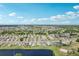 Expansive aerial view of the community, showcasing the beautiful homes, lush landscaping, and water features at 1901 E Del Webb Blvd, Sun City Center, FL 33573