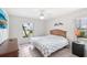Bedroom featuring tile flooring, white walls, and a window with a view of the neighborhood at 1901 E Del Webb Blvd, Sun City Center, FL 33573