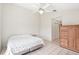 Bedroom with tile floor, ceiling fan, closet, and a wooden dresser at 1901 E Del Webb Blvd, Sun City Center, FL 33573
