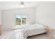 Bedroom with vaulted ceiling, tile floor, and a window overlooking the yard at 1901 E Del Webb Blvd, Sun City Center, FL 33573