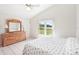 Bedroom featuring a dresser, a window overlooking the lawn, and natural light at 1901 E Del Webb Blvd, Sun City Center, FL 33573