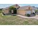 Well-maintained one-story home with lush landscaping and a paved driveway at 1901 E Del Webb Blvd, Sun City Center, FL 33573