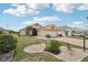 Attractive home with a well-landscaped yard, a paved driveway, and a serene neighborhood setting at 1901 E Del Webb Blvd, Sun City Center, FL 33573