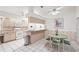 Eat-in kitchen with stainless steel appliances and breakfast bar seating area with green dining set at 1901 E Del Webb Blvd, Sun City Center, FL 33573