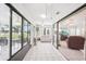 Enclosed lanai with tiled flooring, ceiling fans, and glass windows overlooking a serene view at 1901 E Del Webb Blvd, Sun City Center, FL 33573